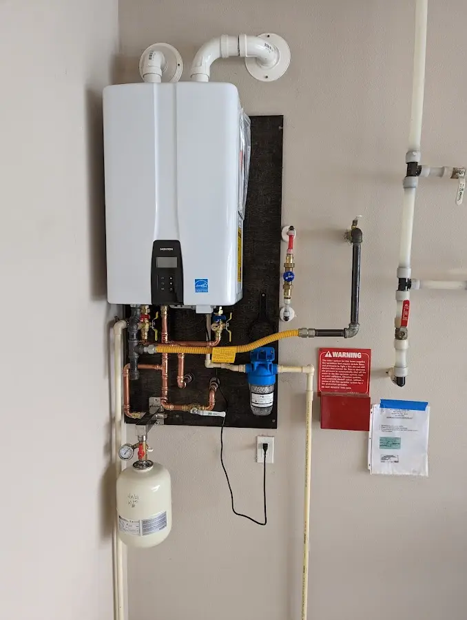 Professional plumber installing copper piping in a Pleasant Prairie home